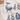 A close-up of a tea towel with an "Ocean" design. The tea towel features a large whale with a scene of a ship sailing inside its body. There are also several puffins and a penguin depicted on the tea towel. The design is colorful and detailed.