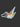 A die-cut sticker of a hummingbird with vibrant green, orange, pink, and blue details, placed on a dark textured surface.