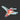 A die-cut sticker of a hummingbird in flight, featuring a vibrant red, orange, and green body with gray wings and a light blue outline, placed on a dark textured surface.