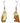 A pair of dangle earrings featuring two barn owls made from recycled paperboard. The earrings have a silver-toned hook and bead. The background of the packaging shows a barn and a night sky with stars. The packaging also includes the text "Jabebo Studio Inspire Curiosity" and "Barn Owl post-consumer paperbourd."