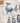 A close-up of a tea towel with an "Ocean" design. The tea towel features a large whale with a scene of a ship sailing inside its body. There are also several puffins and a penguin depicted on the tea towel. The design is colorful and detailed.